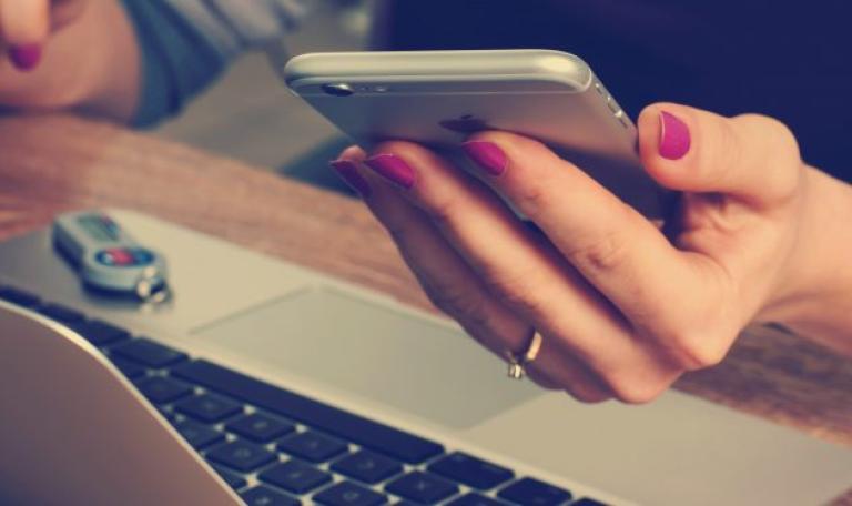 Image of a hand holding a mobile phone