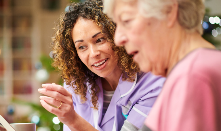 Carer talking to elderly woman