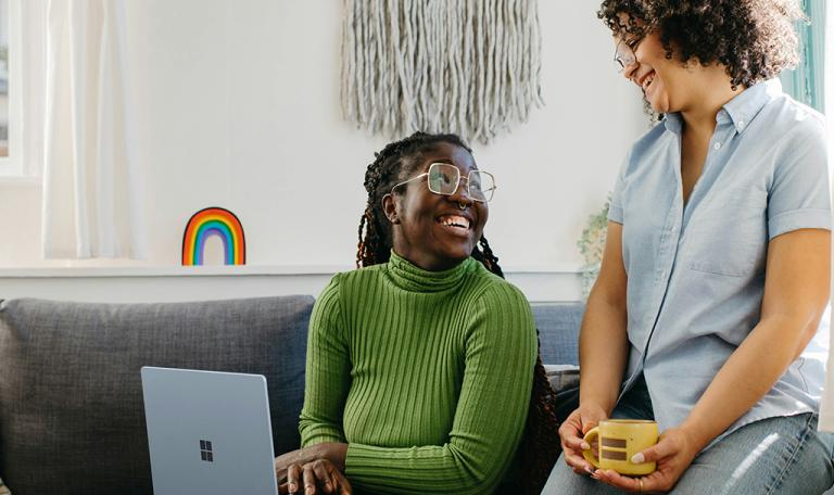 Women chatting about work on a computer