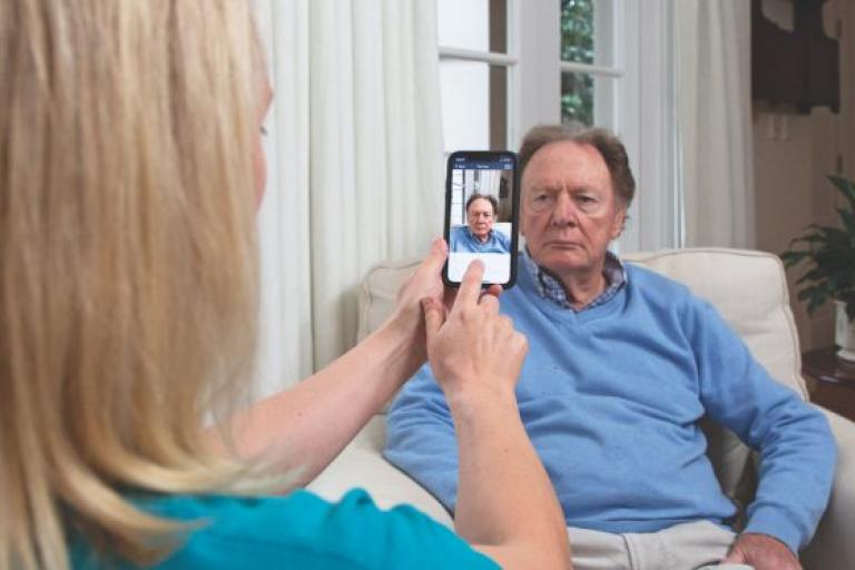 Image showing man having photo taken by care professional.