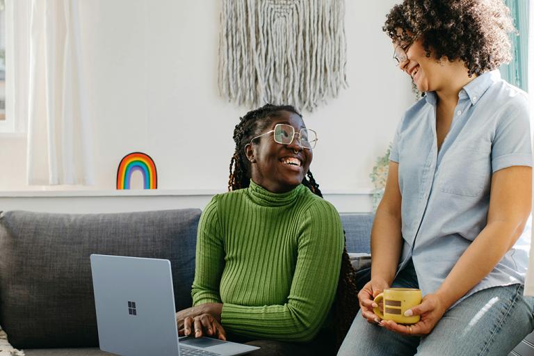 Women chatting about work on a computer